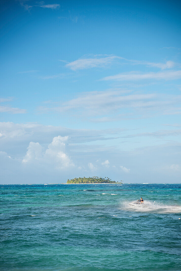 tourist at beach of San Andres rides with Jetski in front of uninhabited island Cayo Santander,  Departamento San Andrés and Providencia, Colombia, Caribbean Sea, Southamerica