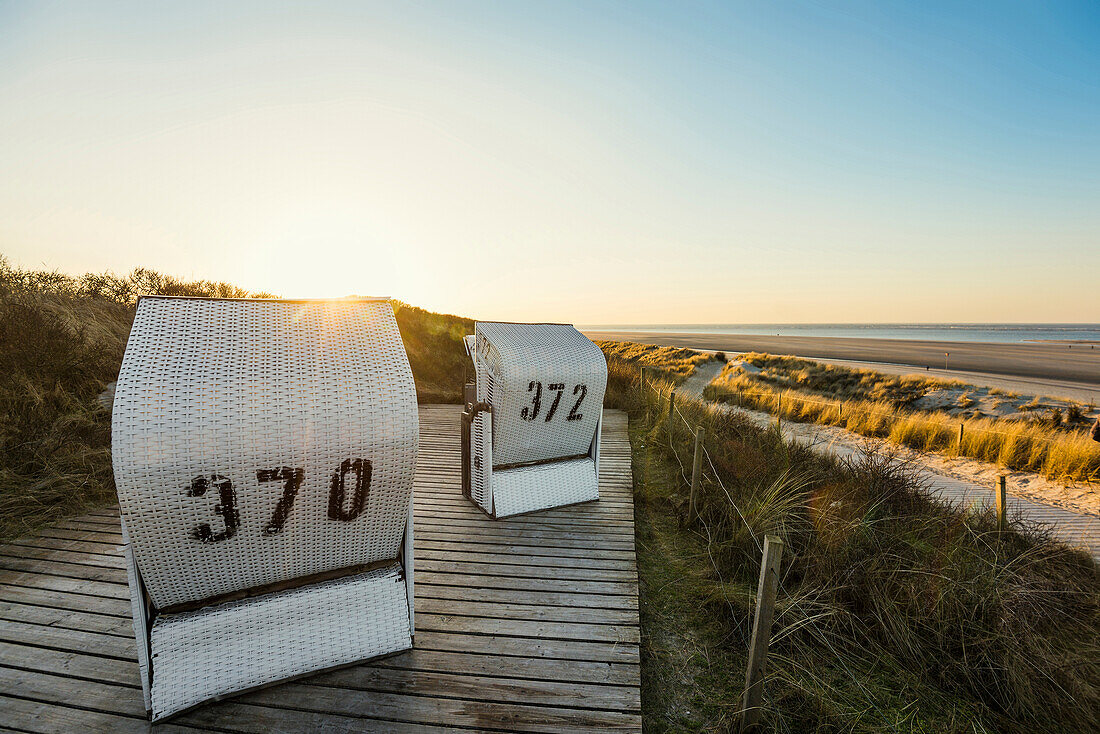 Beach chairs and blue sky in winter, East Frisian Islands, Spiekeroog, Lower Saxony, North Sea, Germany