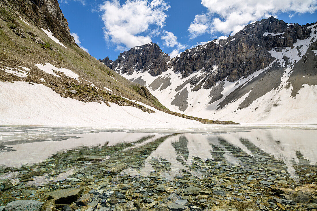 Bergsee mit verschneiten Bergen im Hintergrund, Passo della Cavalla, Val Maira, Cottische Alpen, Piemont, Italien