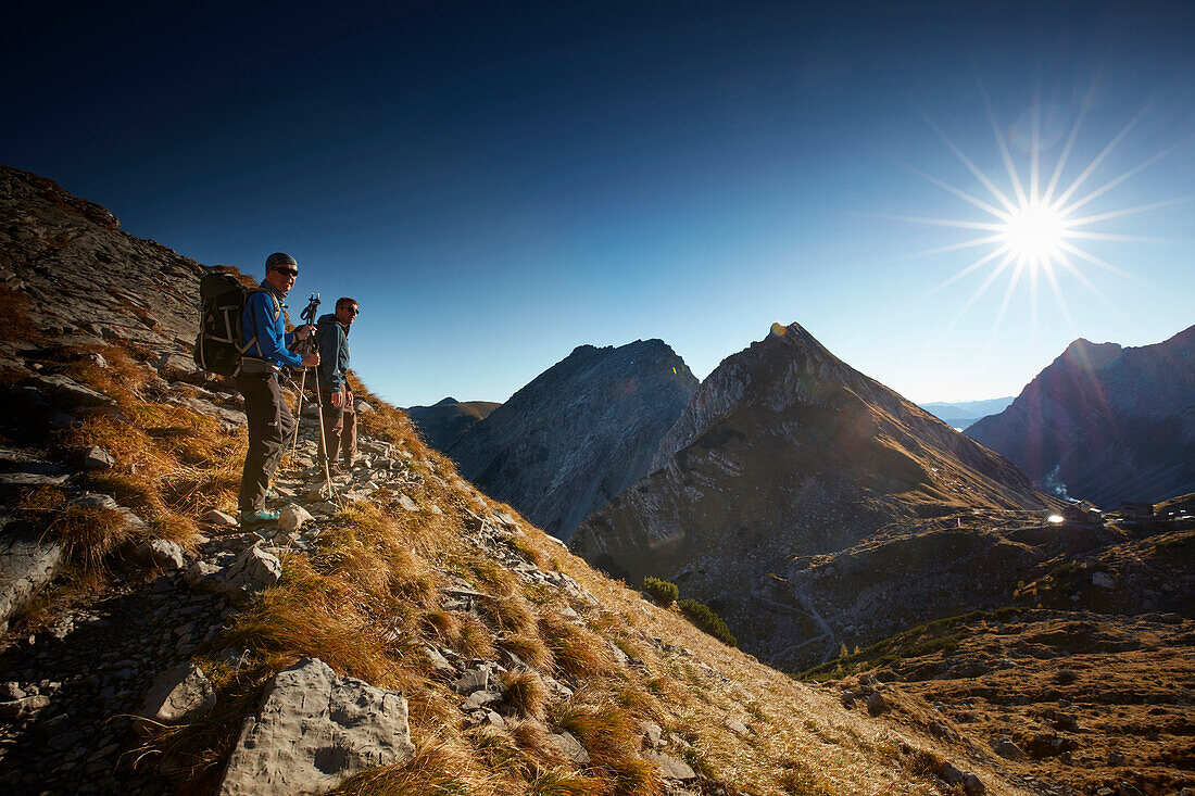 Hikers on the path to Lamsenspitze, Schafjoechl in the back,  Eastern Karwendel Range, Tyrol, Austria