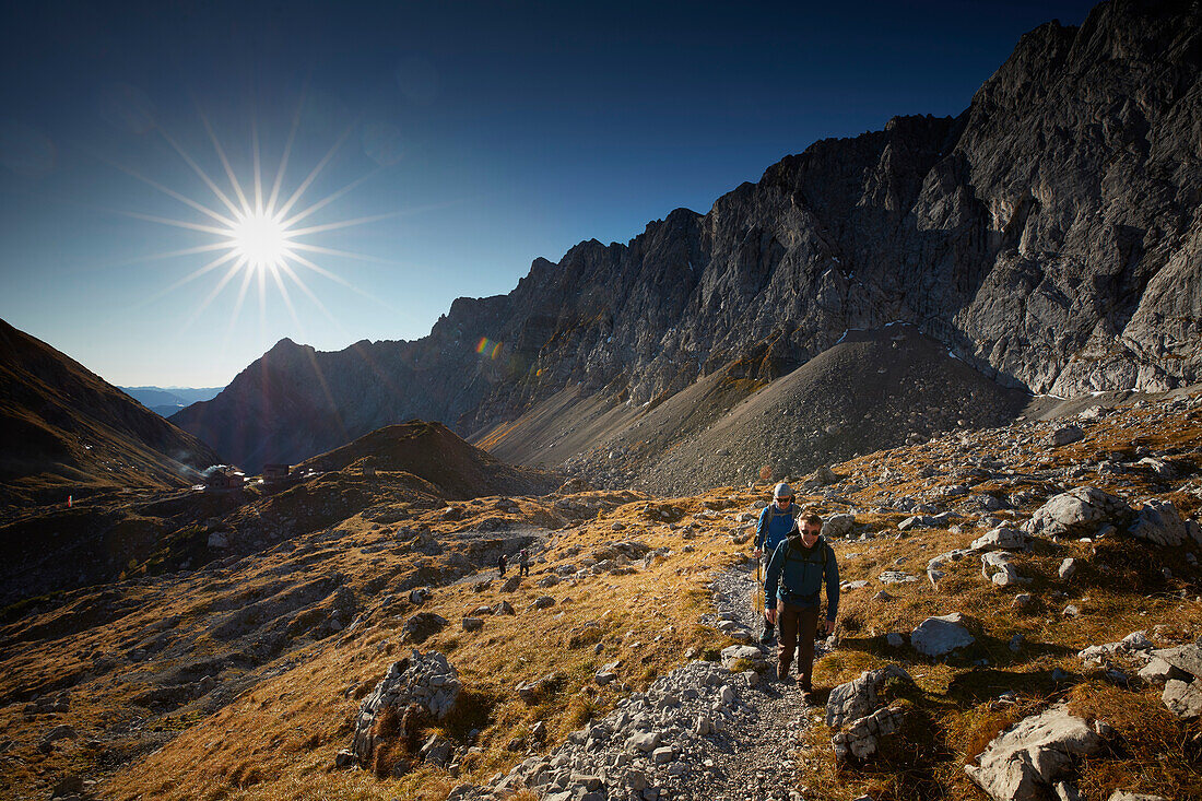 Hikers on the path to Lamsenspitze, Stallenta valley in the back,  Eastern Karwendel Range, Tyrol, Austria