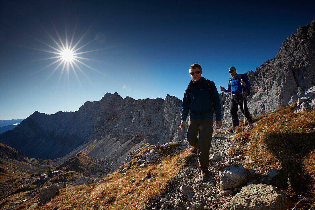 Two hiker coming from Lamsenspitze, Stallental valley in the back,  Eastern Karwendel Range, Tyrol, Austria