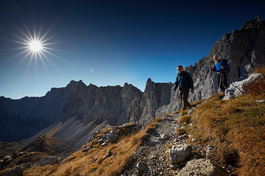 Two hiker coming from Lamsenspitze, Stallental valley in the back,  Eastern Karwendel Range, Tyrol, Austria