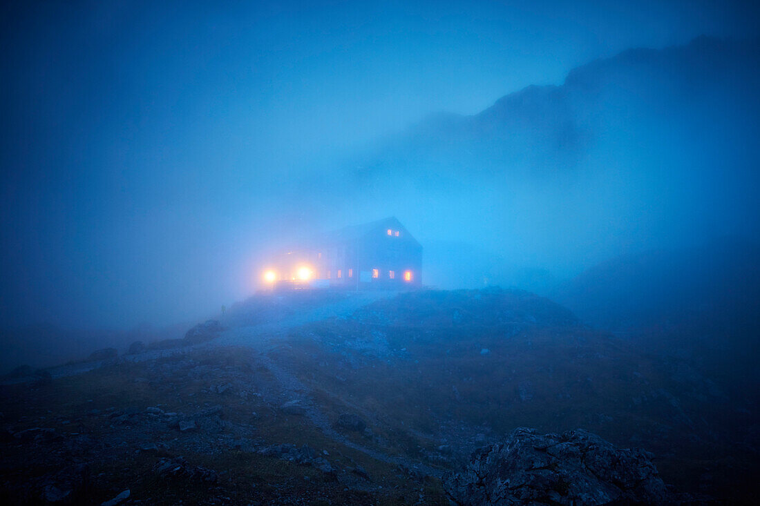 Lamsenjochhuette alpine hut in evening fog,  Eastern Karwendel Range, Tyrol, Austria