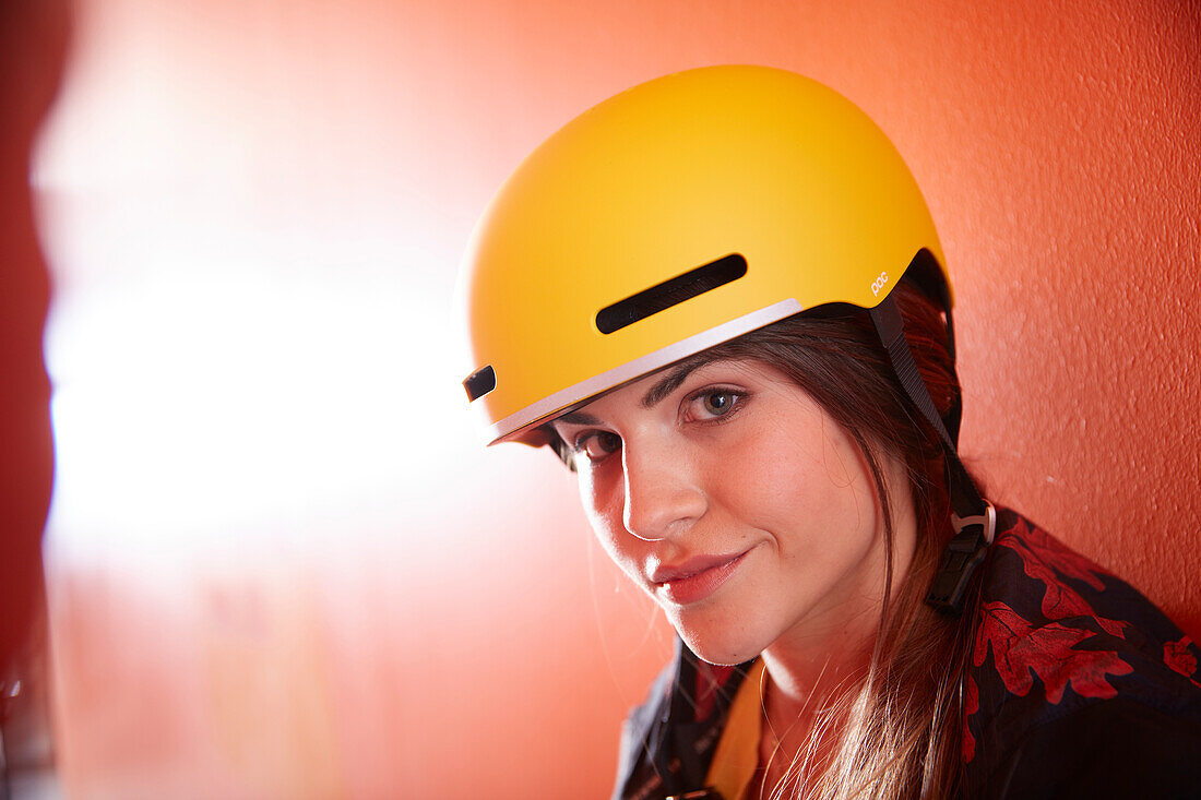 Young  woman with bike helmet in front of a modern facade, Munich, bavaria, germany