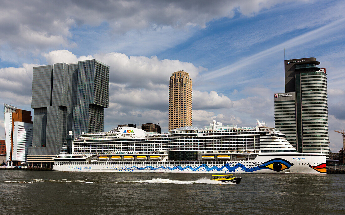 cruise boat in front of the hotel new york against a background of contemporary architecture, city center, rotterdam, holland, the netherlands
