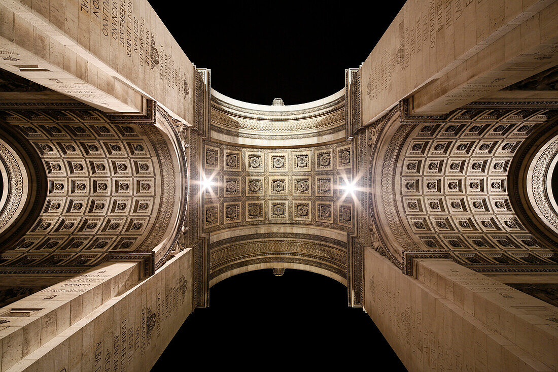 Paris, Place Charles de Gaulle, the Arc de Triomphe by night. View of the ceilings and the architecture.
