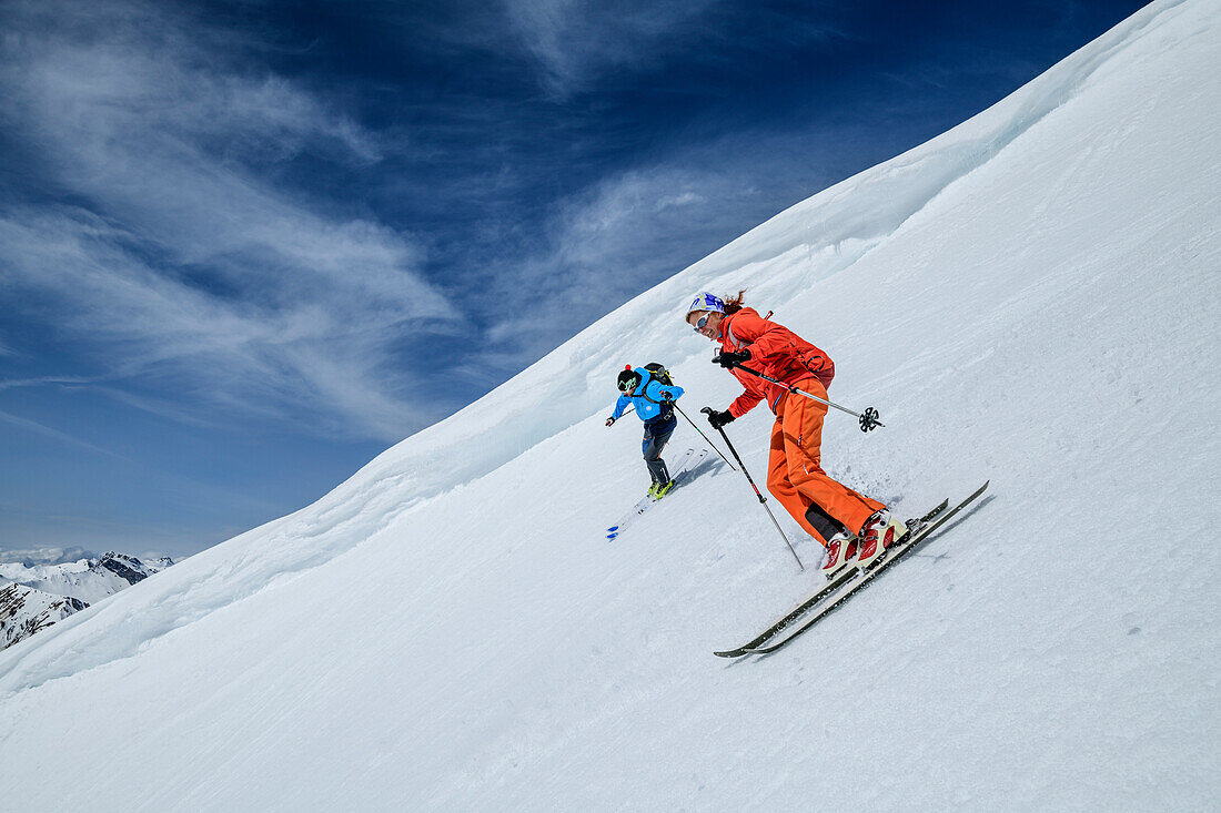 Man and woman backcountry-skiing descending from Rastkogel, Rastkogel, Tuxer Alps, Tyrol, Austria