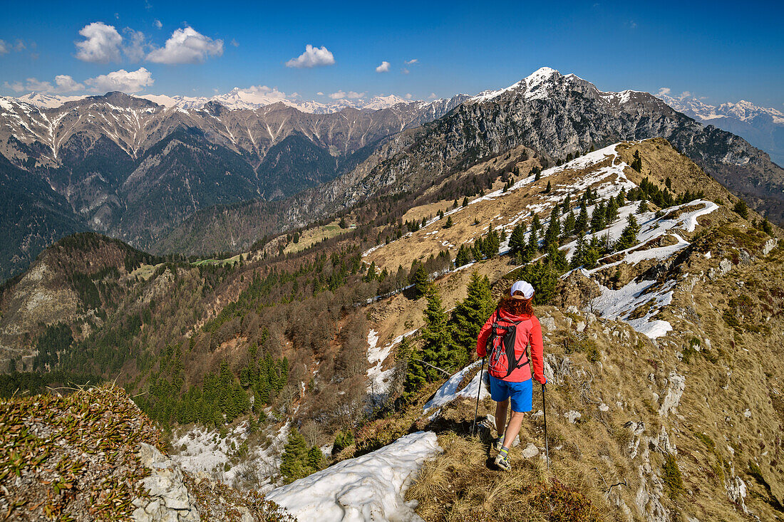 Woman hiking over ridge, Monte Caret, lake Garda, Garda Mountains, Trentino, Italy