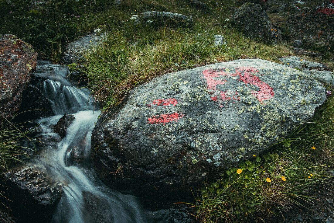 Rock on a mountain stream with signposting mark, E5, Alpenüberquerung, 4th stage, Skihütte Zams,Pitztal,Lacheralm, Wenns, Gletscherstube, Zams to  Braunschweiger Hütte, tyrol, austria, Alps
