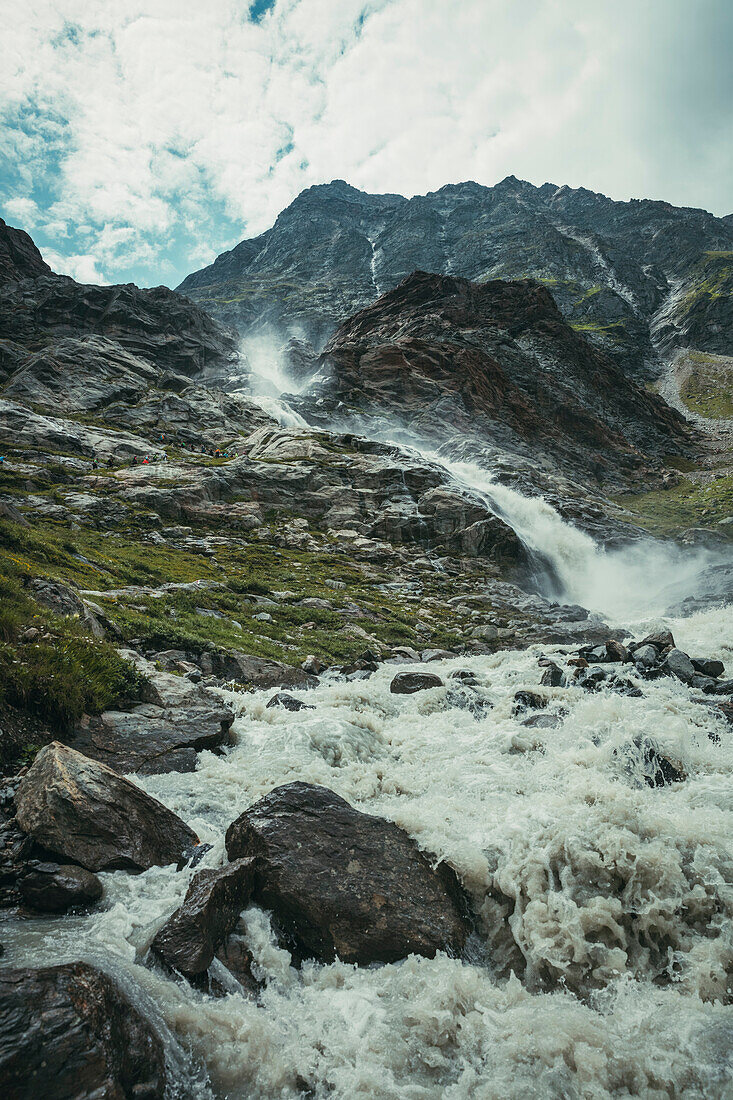 Waterfall in the rock massif with hiking group during the ascent, E5, Alpenüberquerung, 4th stage, Skihütte Zams,Pitztal,Lacheralm, Wenns, Gletscherstube, Zams to  Braunschweiger Hütte, tyrol, austria, Alps