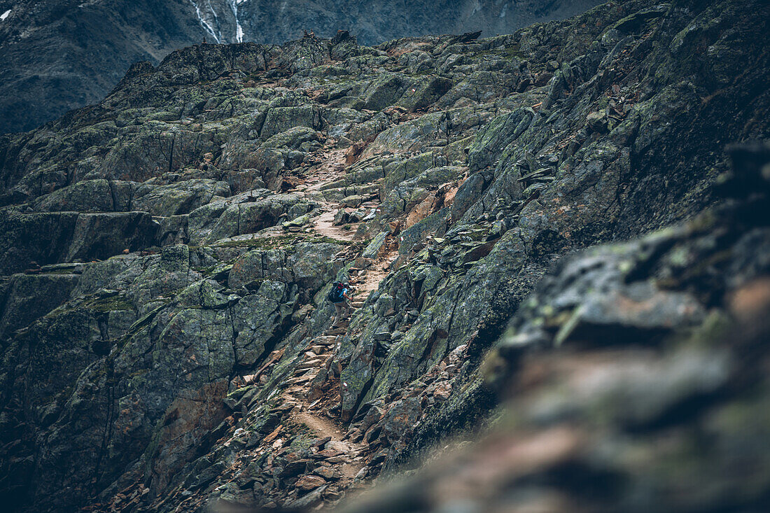Climber climbs over stone stairs on long distance hiking path, E5,Alpenüberquerung,5th stage, Braunschweiger Hütte,Ötztal, Rettenbachferner, Tiefenbachferner, Panoramaweg to Vent, tyrol, austria, Alps