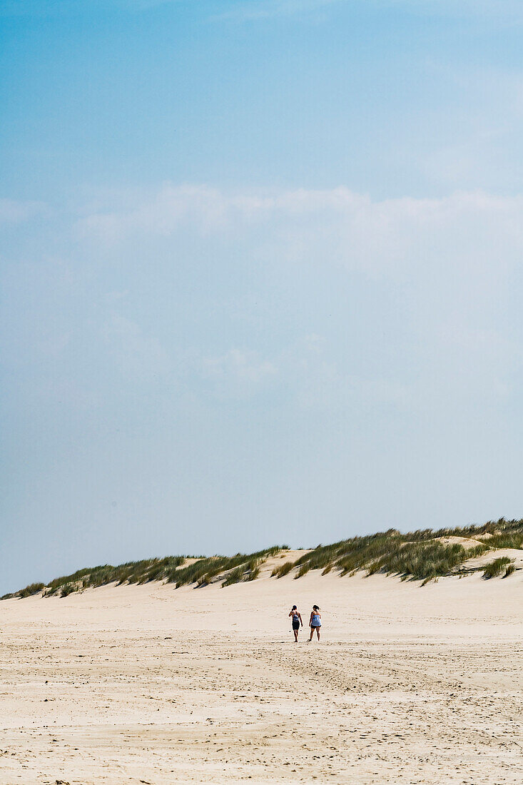 Stroller in front of the dune in the east of the island, Wangerooge, East Frisia, Lower Saxony, Germany
