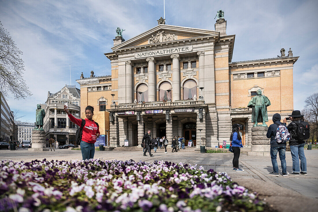 young woman making selfie of her in front of National Theatre (Nationaltheatret), Oslo, Norway, Scandinavia, Europe