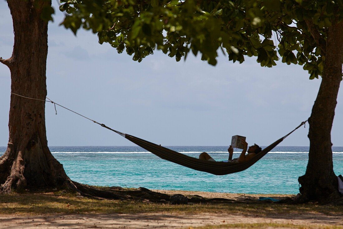 Man relaxing on a hammock in Mauritius.