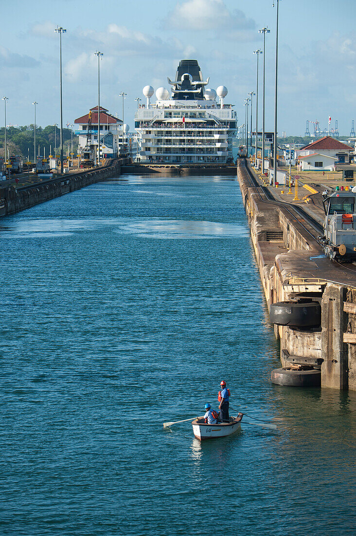 A rowboat awaits the next ship as cruise ship Celebrity Infinity (Celebrity Cruises) is gradually lowered in Gatun Locks on the eastern end of the Panama Canal, Cristobal, Panama, Central America