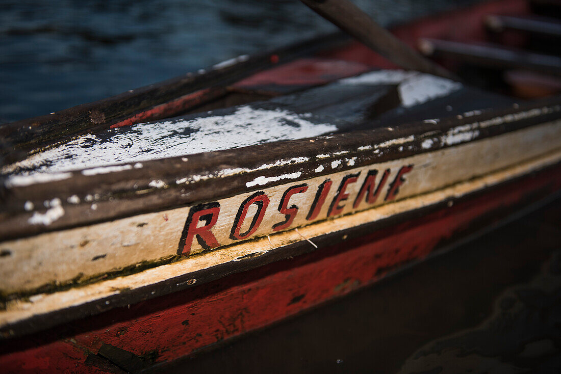 Hand-painted name on a handmade canoe, both in red and black, on a side-arm of the Amazon River, Uara, Amazonas, Brazil, South America