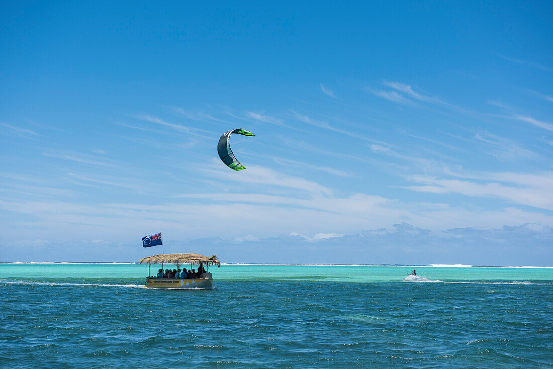 A tour boat returns to shore as a kite-boarder approaches on the right, Rarotonga, Cook Islands, South Pacific