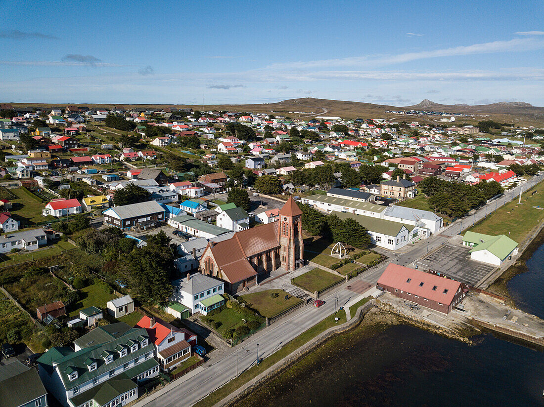 Aerial (drone) view of Stanley and the Christ Church Cathedral (1892), the world's southernmost Anglican cathedral, with its iconic Whalebone Arch at the corner, Stanley, Falkland Islands, British Overseas Territory