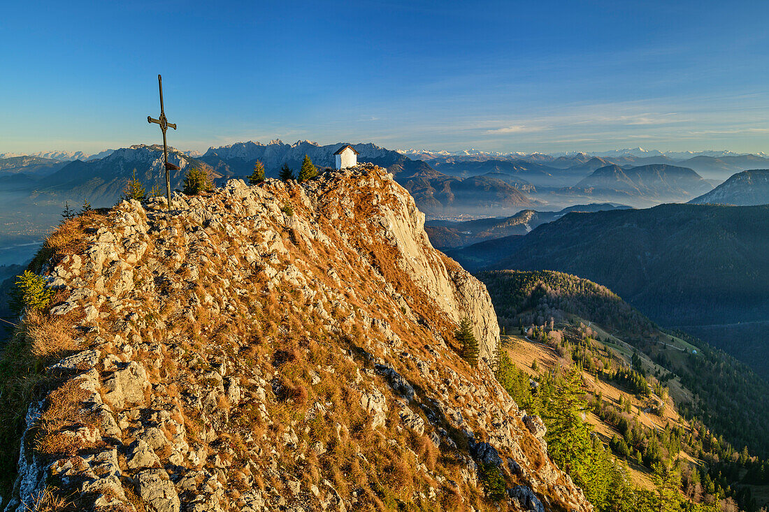 Summit of Bruennstein with cross and chapel, Kaiser range and Central Alps in background, Bruennstein, Mangfall Mountains, Bavarian Alps, Upper Bavaria, Bavaria, Germany