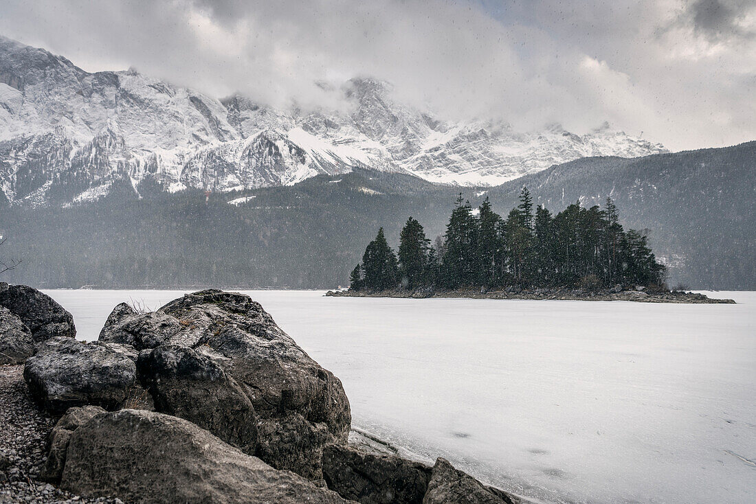 snowfall at frozen Eibsee lake below Zugspitze mountain, Grainau community, Garmisch-Partenkirchen, Bavaria, Alps, Germany