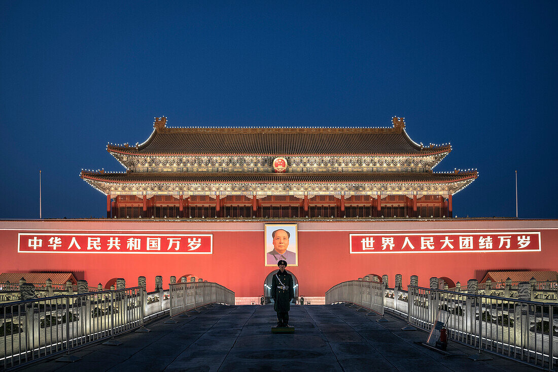 policeman or guard in front of portrait of Mao Zedong at Tiananmen Gate which is the gate to the Forbidden City, Beijing, China, Asia