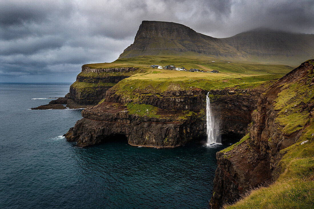 Múlafossur waterfall drops into the Atlantic ocean close by the village of Gásadalur, Vagar, Faroe islands