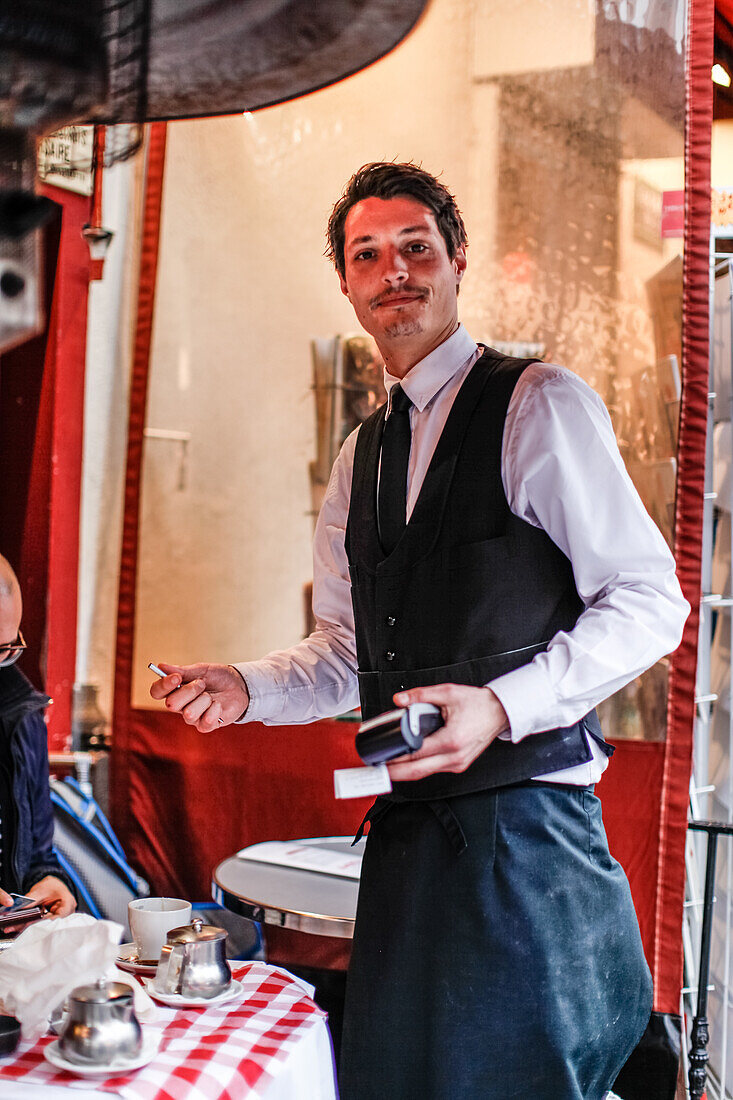 Waiter with the bill in one  hand at the La Mère Catherine restaurant, Place du Tertre, Montmartre, Paris, France, Europe