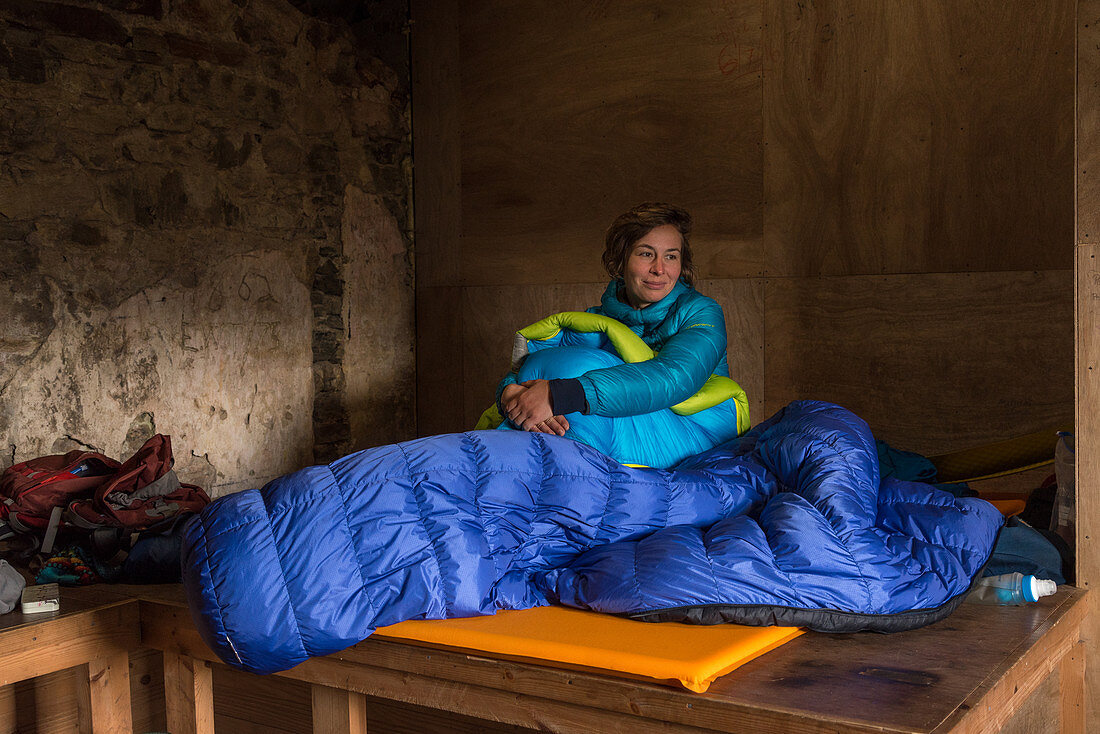 Hiker in Suileag Bothy is waiting for the right weather, Inverpolly Nature Reserve, Highlands, Scotland, UK