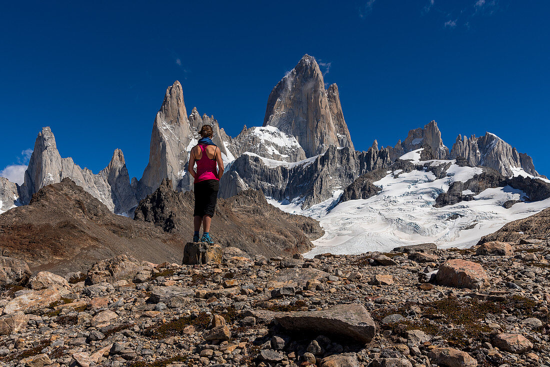 A mountaineer looks out over the Fitz Roy, from Laguna de los Tres, Los Glaciares National Park, Patagonia, Argentina