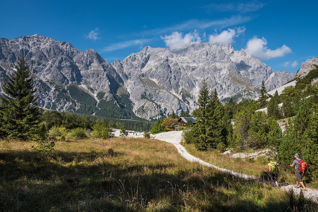 Hiker in front of the Wimbachgries hut, Wimbachtal, Berchtesgaden Alps, Berchtesgaden, Germany