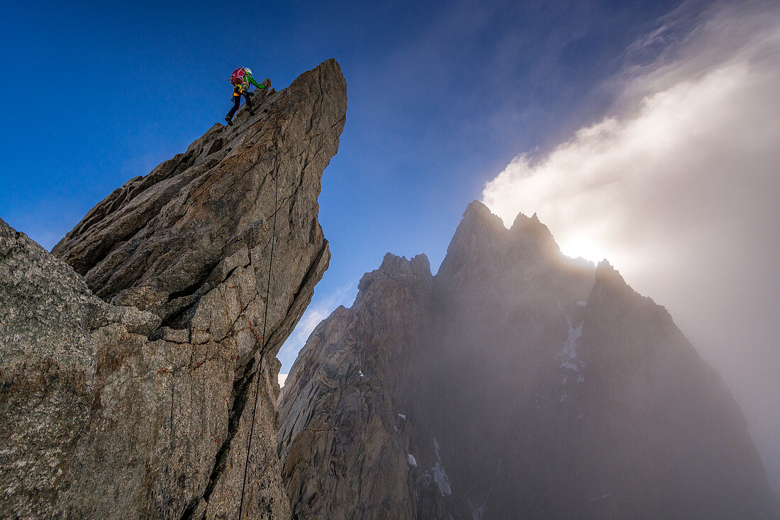 Climber on rock at Pointe Young, Grandes Jorasses, Mont Blanc group, France