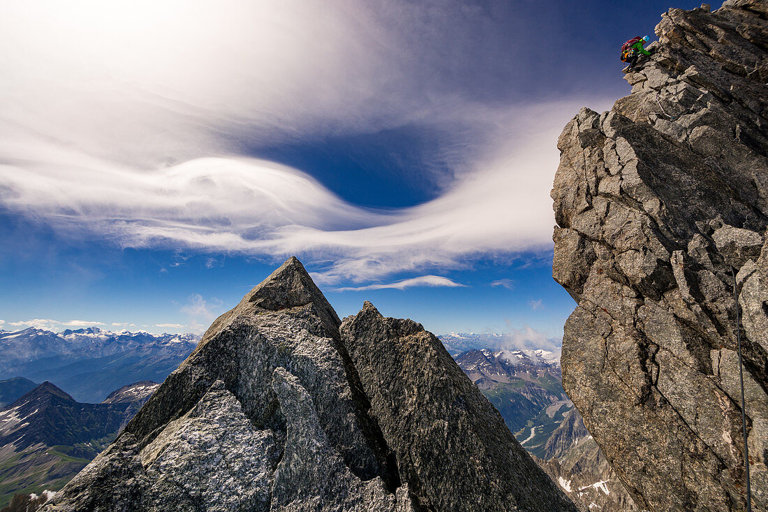 Bergsteigerin beim Abklettern am Fels der Grandes Jorasses, Mont Blanc-Gruppe, Frankreich