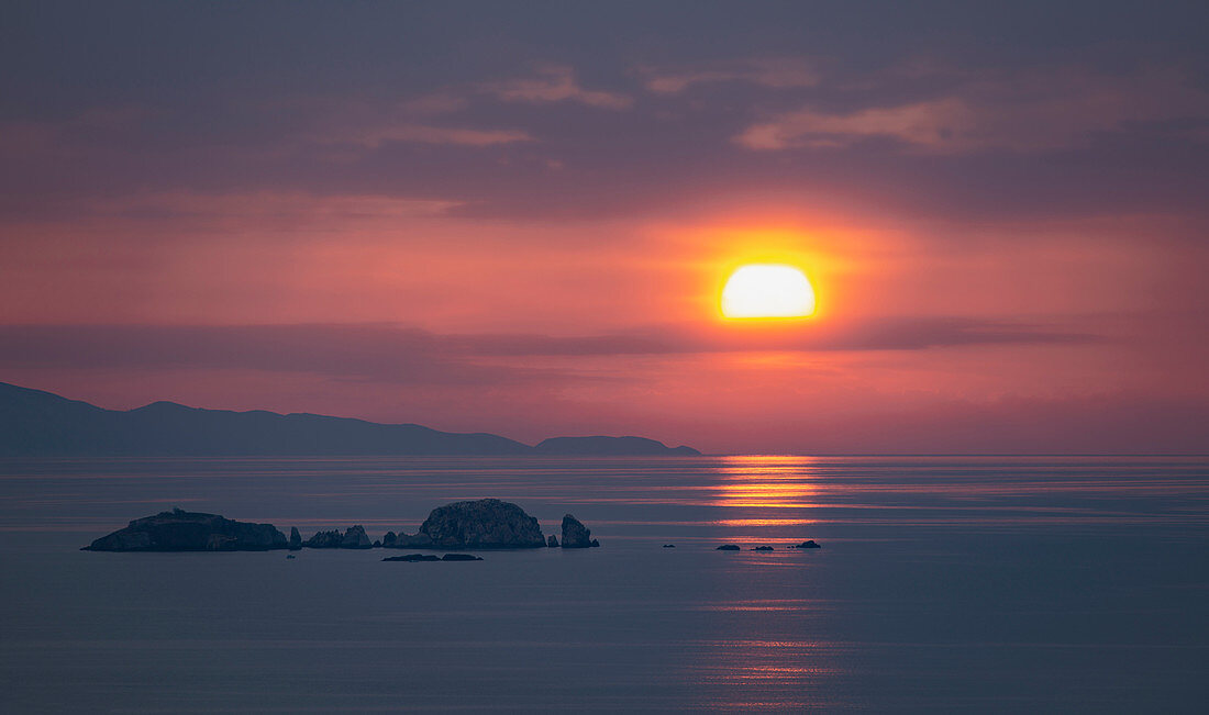 SUN SETS OVER THE AEGEAN SEA, PAROS ISLAND, GREECE