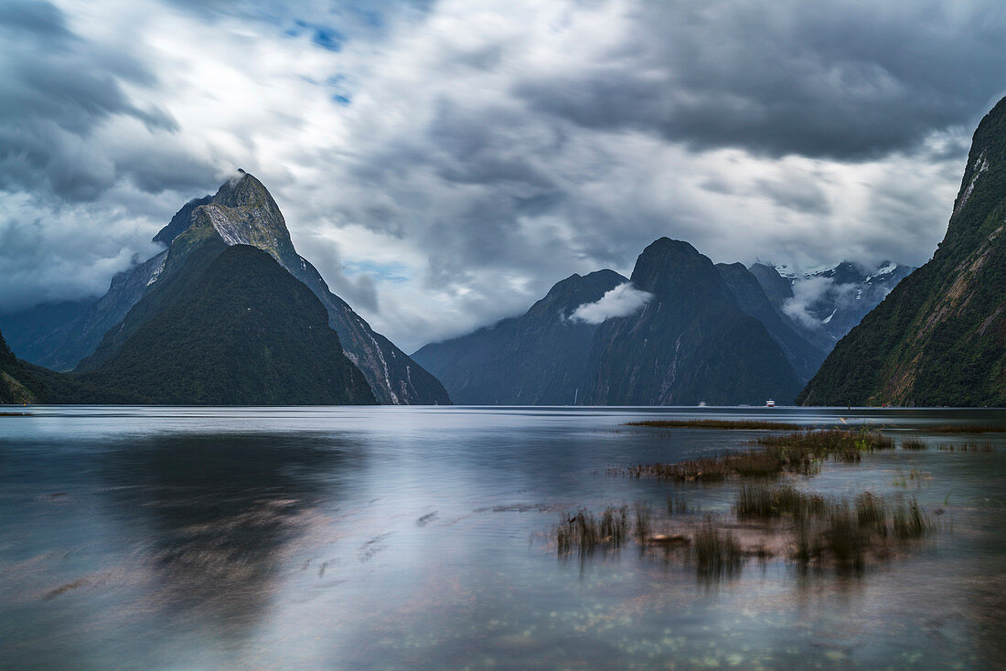 Long Exposure of Milford Sound with low tide on a cloudy summer day. Fiordland NP, Southland district, Southland region, South Island, New Zealand.