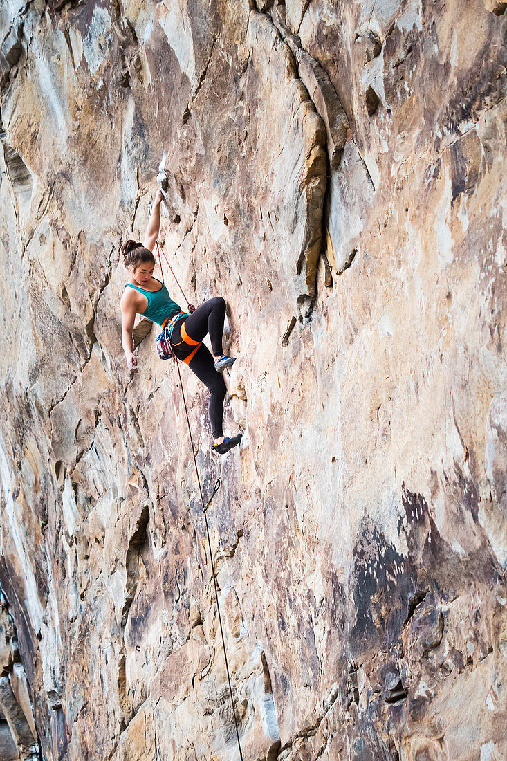 Teenage girl rock climbing