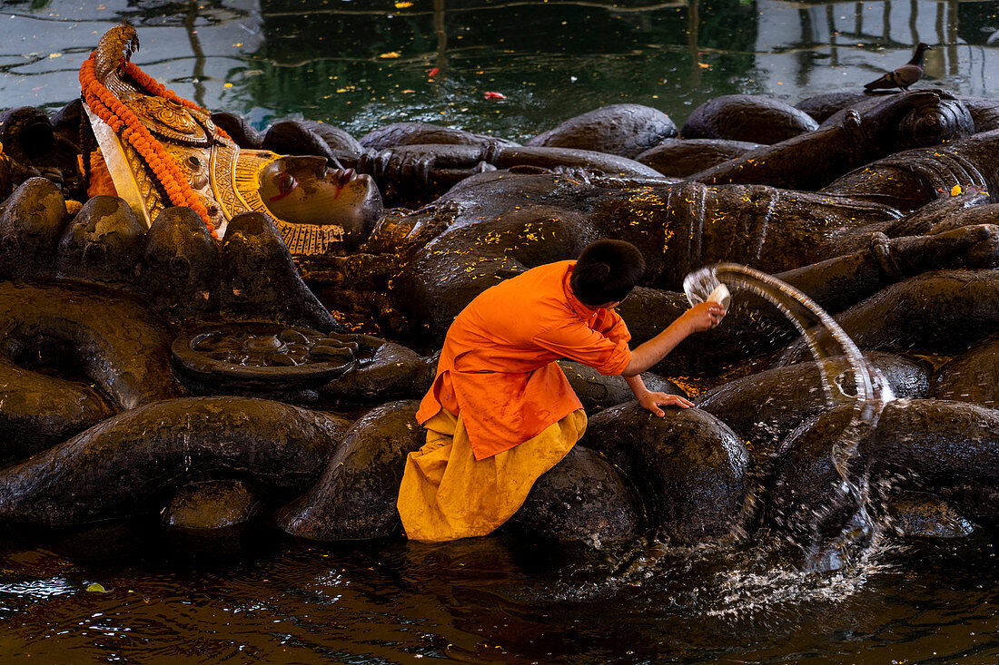 Washing of sleeping Vishnu statue at Budanilkantha, Kathmandu, Nepal. Nepalese, Asia, Asian, Himalayan Country, Himalayas.