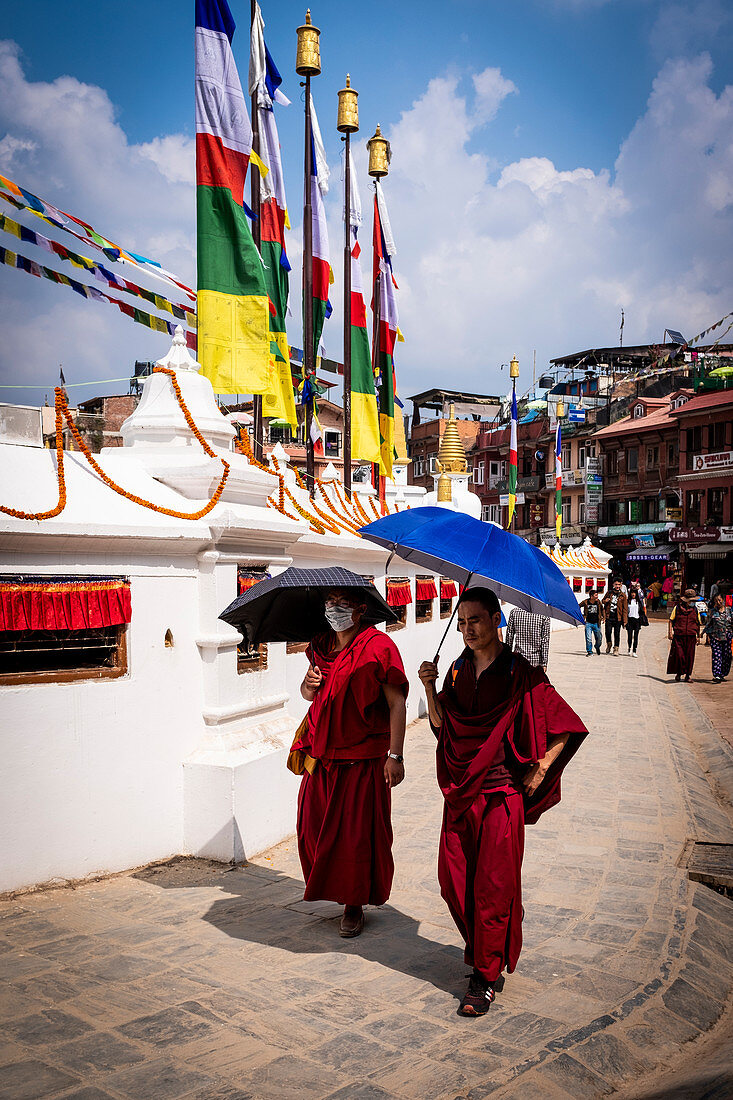 Two monks walking around the Boudhanath Stupa, the Nepal's largest and most important Buddhist monument, Kathmandu, Nepal, Nepalese, Asia, Asian, Himalayan Country, Himalayas.