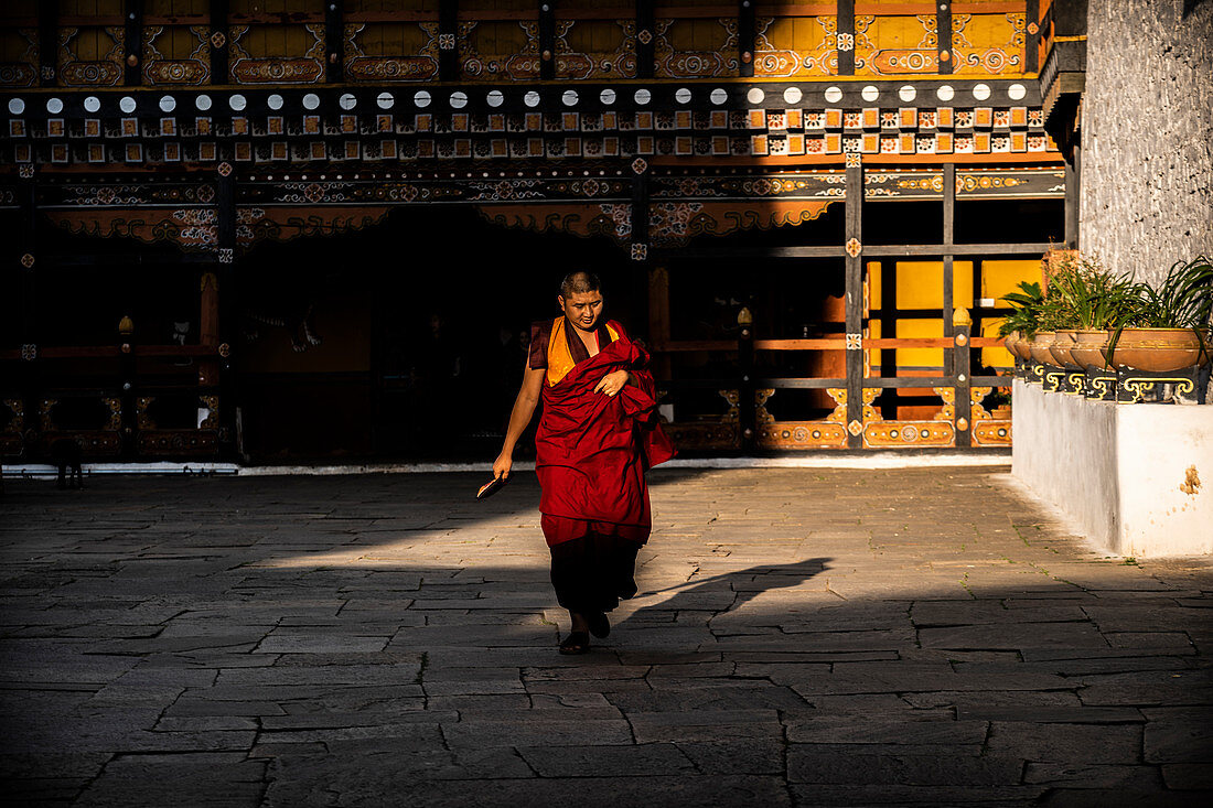 Monk walking at the Rinpung Dzong. Paro, Bhutan, Himalayan Country, Himalayas, Asia, Asian.