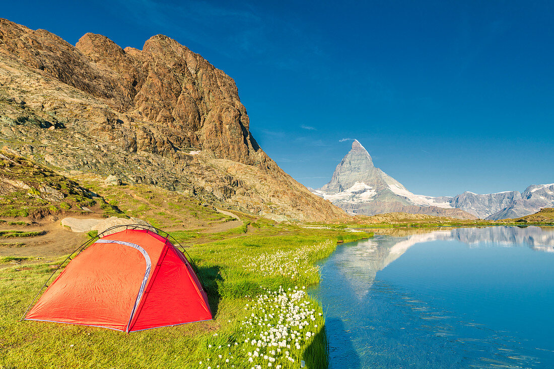 Tent on the shore of lake Riffelsee facing Matterhorn, Zermatt, canton of Valais, Switzerland
