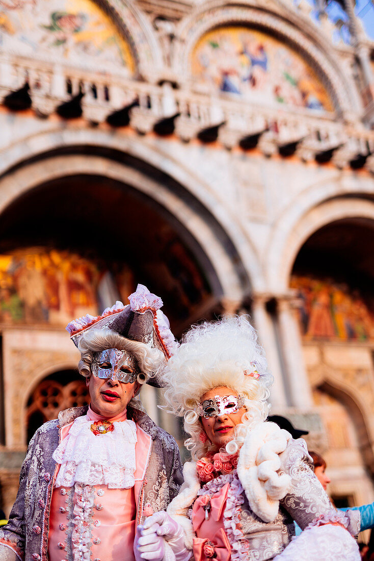 Man and woman in costume and mask at the Venice Carnival, Piazza San Marco (St. Mark's Square), Venice, Veneto, Italy