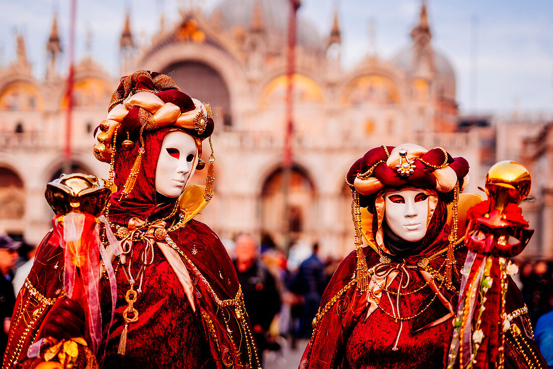 Venice, Italy - Mar 7, 2011: Unidentified Masked Person In Arlecchino  Costume Among Crowd In St. Mark's Square During The Carnival. The 2011  Carnival Was Held From February 26th To March 8th