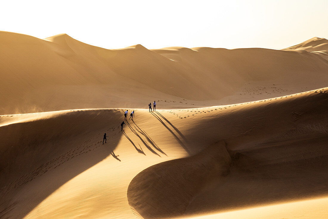 People have fun walking on a sand dune,Walvis Bay,Namibia,Africa