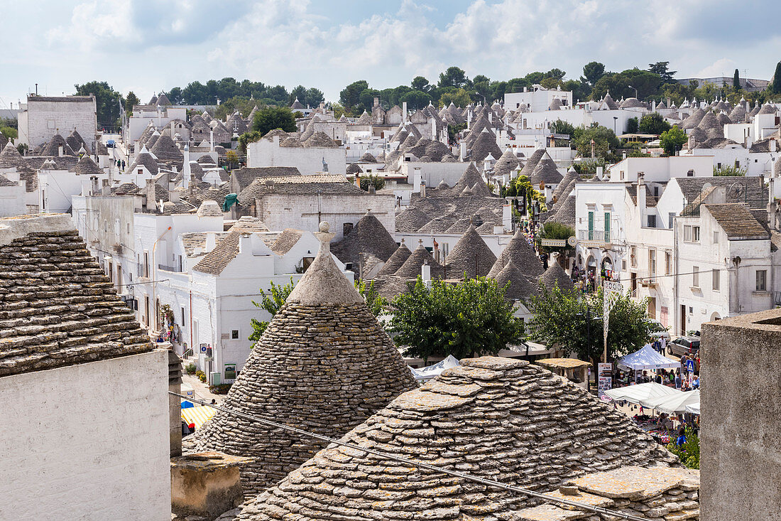 View of the rooftops of the typical Trulli huts of the old village of Alberobello. Province of Bari, Apulia, Italy, Europe.