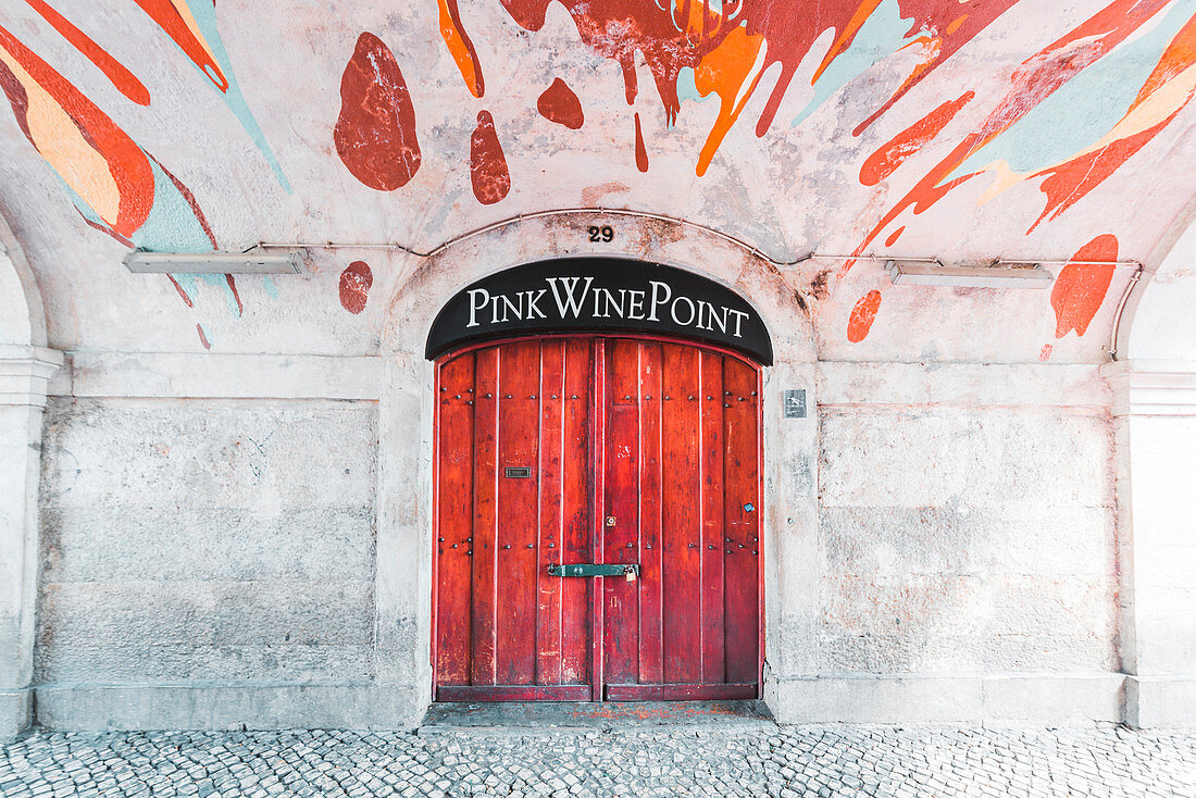 Lisbon, Portugal. Red door and paintings along Cais do Sodre (Pink Street).