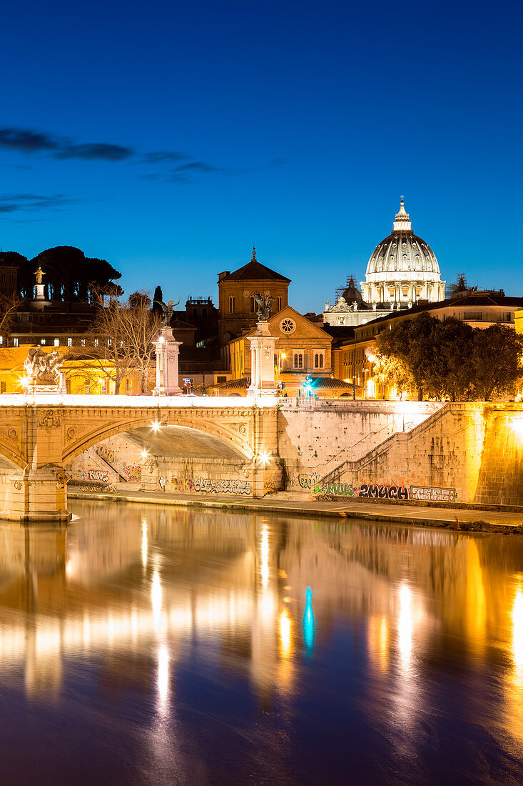 Rome at dusk with view of the dome of Saint Peter's Basilica, Octagonal Tower of the church of the holy spirit in the saxon district and Tiber River Europe, Italy, Lazio, Province of Rome, Rome, dusk