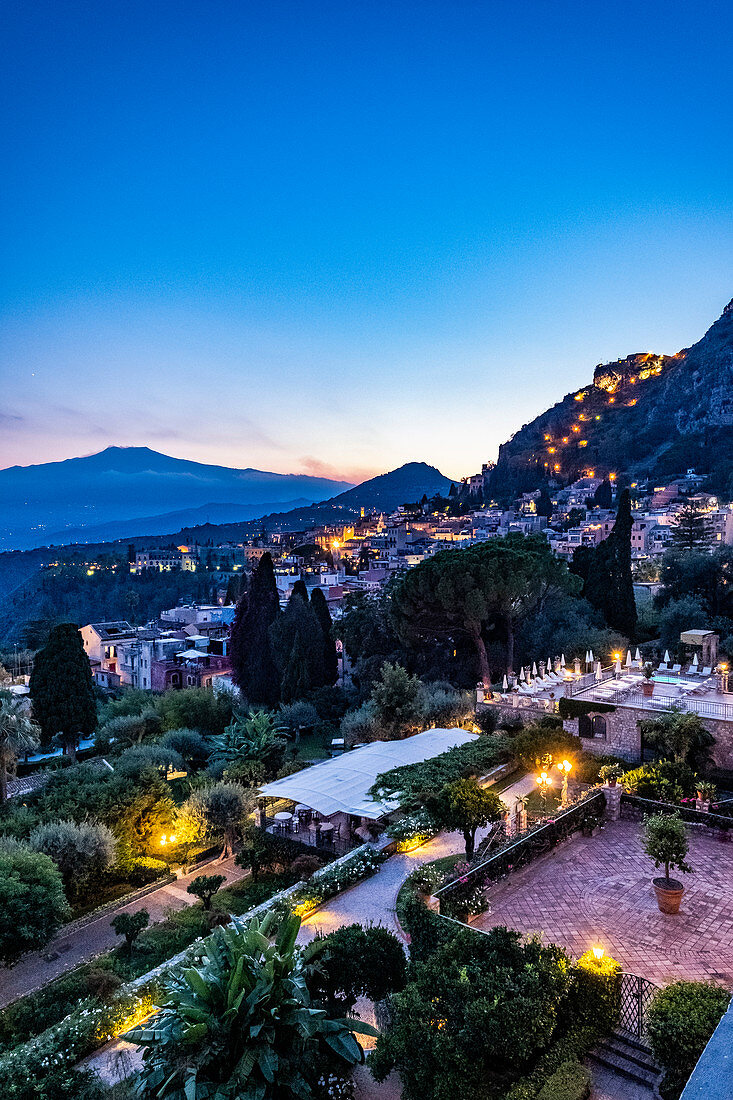 Sunset view from the terrace of the Grand Hotel Timeo to the volcano etna and Taormina, Sicily, South Italy, Italy