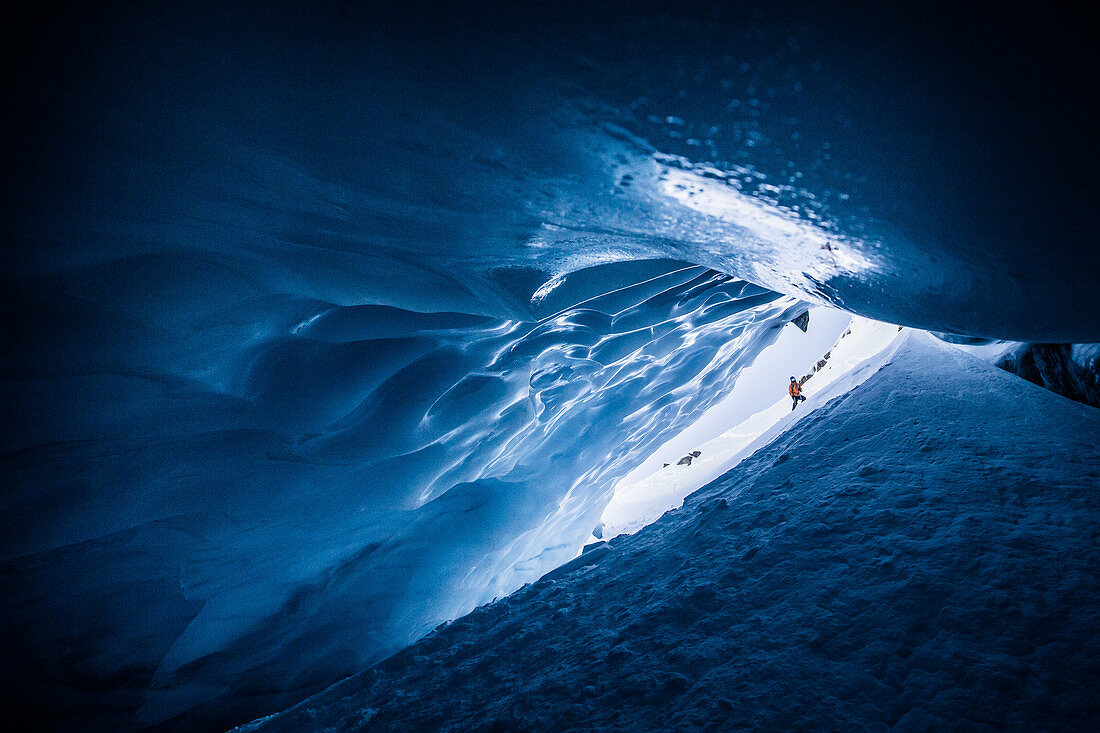Skier infront an ice cave, Pitztal, Austria,