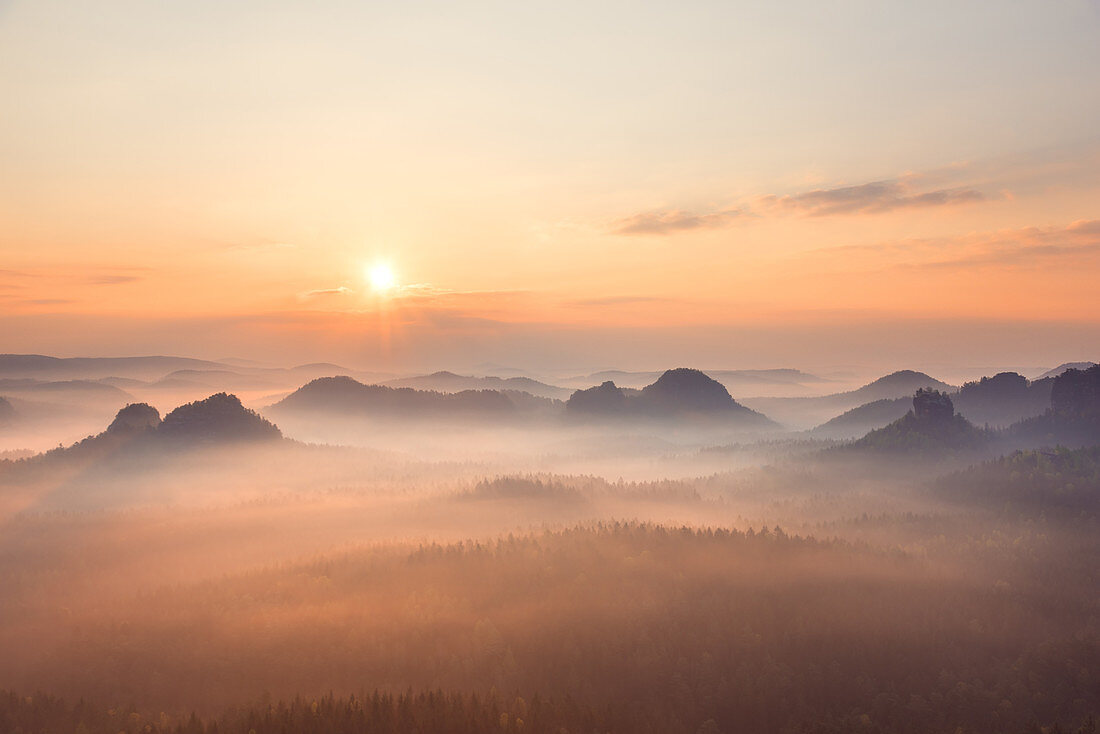 Misty sunrise over the Kleinen Winterberg hill, Saxon Switzerland highlands, Saxony, Germany, Europe