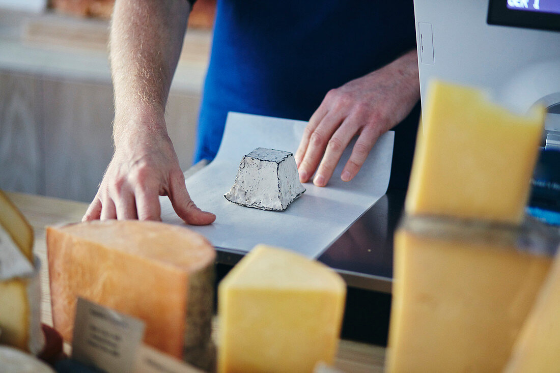 Cheeseseller wrapping up goats cheese